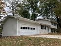 Newly painted house with attached garage and landscaping at 3666 Elkridge Dr, Decatur, GA 30032