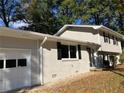 Newly painted house with white garage door and landscaping at 3666 Elkridge Dr, Decatur, GA 30032