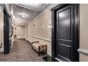 Building hallway with dark wood door and seating at 2300 Peachford Rd # 1209, Atlanta, GA 30338