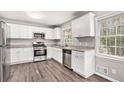 Modern kitchen with white cabinets and granite countertops at 3276 Marlanta Dr, Marietta, GA 30062