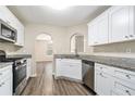 Kitchen with white cabinets, granite countertops, and stainless steel appliances at 6943 Fairway Trl, Austell, GA 30168