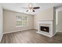 Living room with fireplace, ceiling fan, and wood-look flooring at 6943 Fairway Trl, Austell, GA 30168
