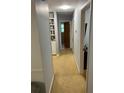 A long hallway with carpeted floors and neutral walls at 2218 Beech Valley Se Dr, Smyrna, GA 30080