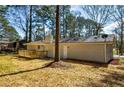 Rear view of a renovated home showcasing a new deck and private backyard at 1328 White Oak Se St, Conyers, GA 30013