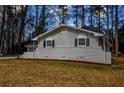 Side view of a charming brick ranch home with mature trees at 1328 White Oak Se St, Conyers, GA 30013