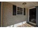 Front entry with black door, stone flooring and updated shutters at 1328 White Oak Se St, Conyers, GA 30013