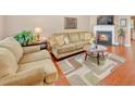 Living room with a fireplace, hardwood floors, and neutral-toned furniture at 176 Spring Walk Way, Lawrenceville, GA 30046