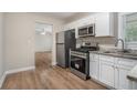 Updated kitchen with white cabinets, stainless steel appliances, and granite countertops at 1883 Cindy Dr, Decatur, GA 30032