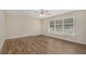 Living room with wood-look flooring and large windows at 1883 Cindy Dr, Decatur, GA 30032