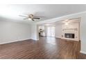 Open living room with dark wood floors and a brick fireplace at 6275 S Skyline Dr, Douglasville, GA 30135