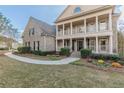 Two-story brick home with a front porch and landscaped yard at 4348 Meadow Vista Dr, Stonecrest, GA 30038