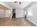 Spacious living area with hardwood floors, stairs, and ceiling fan at 7543 Palmetto Way, Riverdale, GA 30274