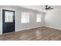 Bright living room with hardwood floors and ceiling fan at 7543 Palmetto Way, Riverdale, GA 30274