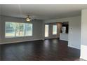 Spacious living room with hardwood floors, large windows and ceiling fan at 3270 Forest Green Dr, Douglasville, GA 30135