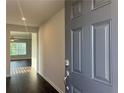Bright entryway with dark hardwood floors and view into living room at 3270 Forest Green Dr, Douglasville, GA 30135