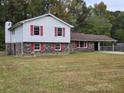 Brick ranch house with red shutters and carport at 7437 Grayson Dr, Riverdale, GA 30296