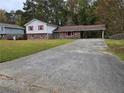 Brick ranch house with red shutters and carport at 7437 Grayson Dr, Riverdale, GA 30296