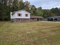 Brick ranch house with red shutters and carport at 7437 Grayson Dr, Riverdale, GA 30296