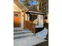 Front steps with a modern, clean design and a bright orange door at 2688 Landington Way, Duluth, GA 30096