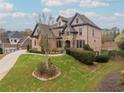 Two-story home with stone and brick exterior, landscaping, and driveway at 3960 Carissa Trce, Cumming, GA 30040