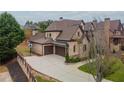 Brick home with three-car garage and a basketball court at 3960 Carissa Trce, Cumming, GA 30040