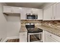 Modern kitchen with granite countertops and stainless steel appliances at 103 Autumn Way, Stockbridge, GA 30281