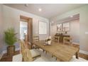 Dining room with hardwood floors and farmhouse table at 7620 Woolf Way, Cumming, GA 30028