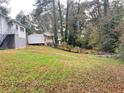 Spacious backyard with steps leading down to a wooded area at 6185 Bermuda St, Forest Park, GA 30297