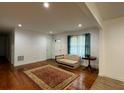 Bright living room with hardwood floors, a decorative rug, and ample natural light at 2194 Klondike Sw Rd, Conyers, GA 30094