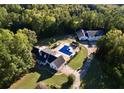 Aerial view of property showcasing house, pool, detached garage, and large lot at 8948 Ephesus Church Rd, Villa Rica, GA 30180