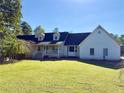 White ranch house with large yard, double garage and front porch at 8948 Ephesus Church Rd, Villa Rica, GA 30180