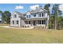 Two-story brick home with gray shutters and a metal roof at 6108 Hutchins Dr, Buford, GA 30518