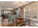 Bright dining area with a rustic wooden table and light-green cabinets at 215 Mackenzie Ct, Canton, GA 30115