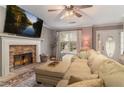 Spacious living room with a stone fireplace and large sectional sofa at 215 Mackenzie Ct, Canton, GA 30115