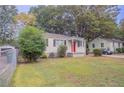 Charming white brick ranch home with a red door at 2519 Godfrey Nw Dr, Atlanta, GA 30318