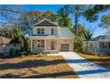 Two-story house with gray accents, front porch, and driveway at 2126 Seavey Dr, Decatur, GA 30032