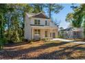 Two-story house with a landscaped yard, driveway and trees at 2126 Seavey Dr, Decatur, GA 30032