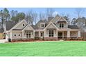 Two-story home with neutral siding, brick accents, and a welcoming front porch at 234 Aberdeen Way, Woodstock, GA 30188