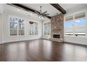 Open living area with hardwood floors, fireplace, and abundant natural light at 234 Aberdeen Way, Woodstock, GA 30188