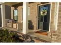 Dark-stained front door with a white floral wreath at 573 Auburn Crossing Dr, Auburn, GA 30011