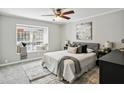 Bright bedroom with a window seat, ceiling fan, and cozy bedding at 29 La Rue Nw Pl, Atlanta, GA 30327