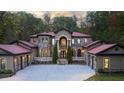 Grand estate home with stone and stucco facade, red roof, and gated entry at 1416 Walcutts Nw Way, Marietta, GA 30064