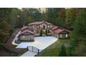 Luxury home with stone and stucco exterior, gated entry, and large driveway at 1416 Walcutts Nw Way, Marietta, GA 30064