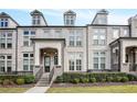 Three-story townhome with light brick exterior and landscaping at 2341 Brissett Ln, Brookhaven, GA 30319