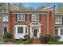 Brick townhouse with white trim and landscaping at 5417 Trentham Dr, Dunwoody, GA 30338