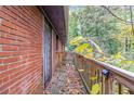 Brick building with wooden deck and railing, surrounded by trees at 2314 Omaha Sw Rd, Atlanta, GA 30331
