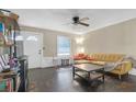 Bright living room with hardwood floors, a couch, and a ceiling fan at 2314 Omaha Sw Rd, Atlanta, GA 30331
