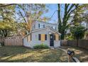 Gray sided two-story house with a fenced backyard and mature trees at 1870 S Columbia Pl, Decatur, GA 30032