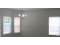 Bright dining room with neutral walls, crown molding, and three windows at 6511 Grey Fox Way, Riverdale, GA 30296