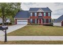 Brick two story house with a two car garage at 226 Graymist Ln, Loganville, GA 30052